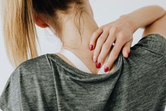 Woman Touching Her Back